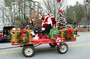The ROTARY FLYER carries Santa and Mrs. Claus and an elf in the parade.